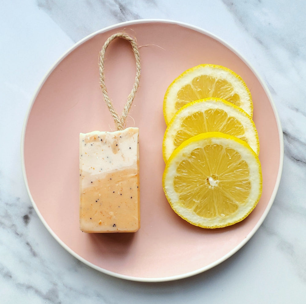 Lemon & Poppy Seed Shaving Soap made with high quality oils and butters, including Cocoa Butter and Almond Oil. Each bar is unique because it is hand swirled and hand-cut and has a hemp rope attached to allow it to be hung.